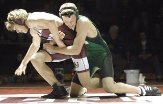 Chad Coleman/Mercer Island Reporter Islander Sam Bliss stuggles to get free from his Skyline opponent’s grasp during a critical match Thursday at Mercer Island High School.