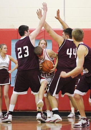 Chad Coleman/Mercer Island Reporter Islanders Drew Sexton (23) and Jack Gala (44) double-team a Sammamish player on Thursday. The Mercer Island defense shut out the Totems during the first quarter of the game.