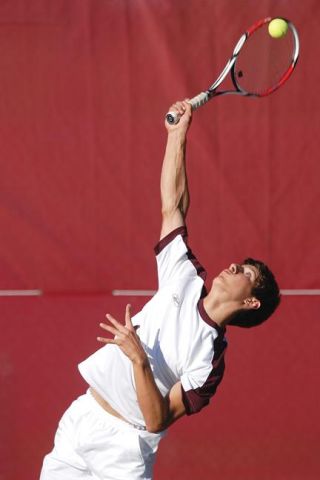 Chad Coleman/Mercer Island Reporter Islander Matt Ellis smashes a serve during the No. 1 singles match against Bellevue.