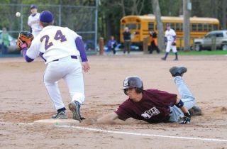 Chad Coleman/Mercer Island Reporter Islander second baseman Joey Scalzo dives back to the bag on a pick-off attempt against Issaquah Thursday at Island Crest Park.