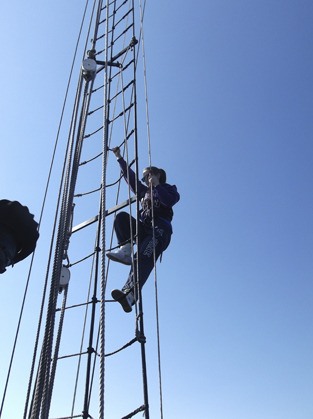 Esther Goldberg climbs the rigging on the Adventuress.