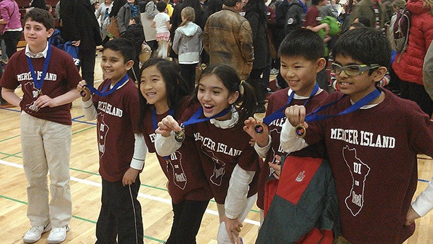 The Six Sparks team members show off the medals they won at the Destination Imagination Regional Tournament at Mercer Island High School.