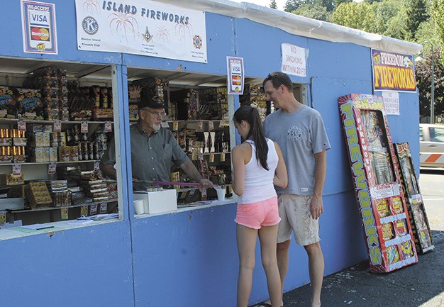 Charlie Young and his daughter Caroline look at the fireworks selection