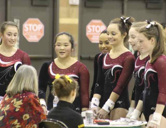 The MIHS gymnastics team meets with the bars judge before the bears portion of the 3A KingCo championships on Saturday