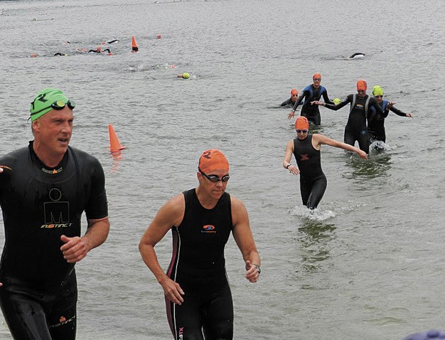 Racers climb out of the water and begin the second leg of the Islander Aquathon