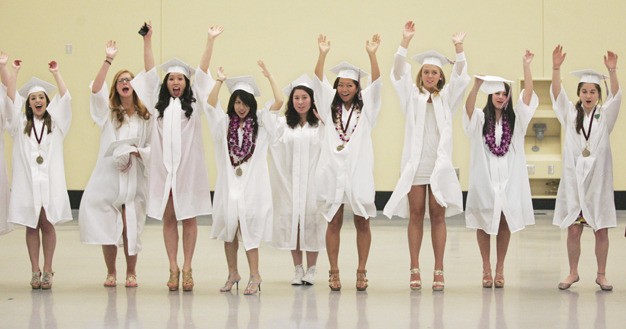Graduating seniors from Mercer Island High School waiting in line for the ceremony to begin pass the time doing “the wave.”