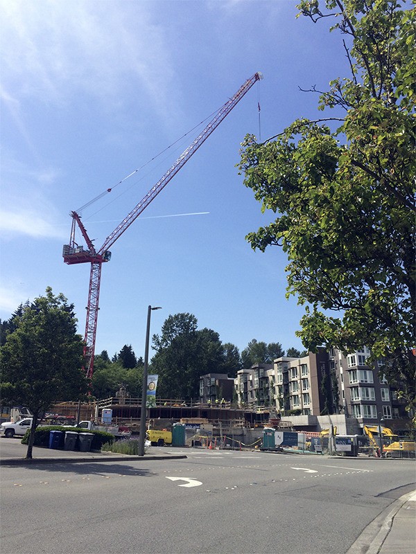 A crane is used in May 2015 to help build the Hadley apartment project. The crane will be dismantled this weekend.