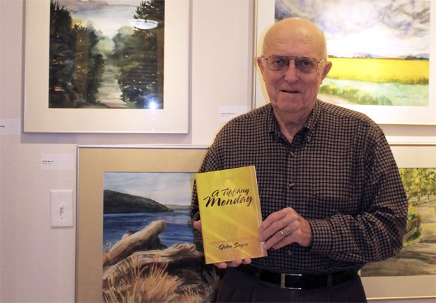 John Sager of Mercer Island holds up his book