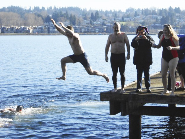 Swimmers jump into Lake Washington on Tuesday