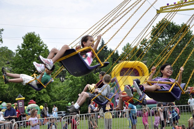 Kids take a spin in Mercerdale Park during Summer Celebration on Saturday