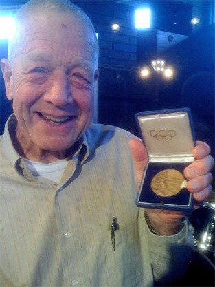 Carl Lovsted holds his bronze medal from the 1952 Olympics.