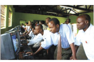 Ugandan students get a look at their new computers donated by Forest Ridge students.