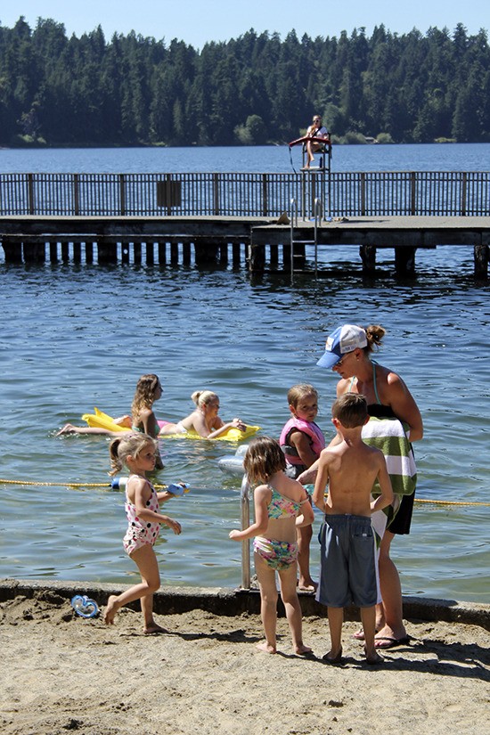 A family prepares for an afternoon at Groveland Park beach in late July