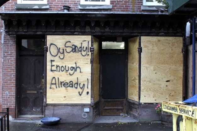 The message on a window covered by plywood in New York City shows the general distress brought on by Hurricane Sandy.