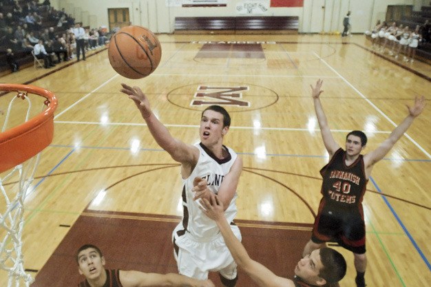 Mercer Island senior forward Brian Miller goes up for a shot during last winter’s home game against Sammamish. He