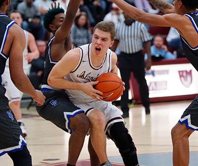 Mercer Island’s Emerson Schulz fights into the paint through Desert Pines defenders Dec. 29 during the MaxPreps Holiday Classic in Palm Springs
