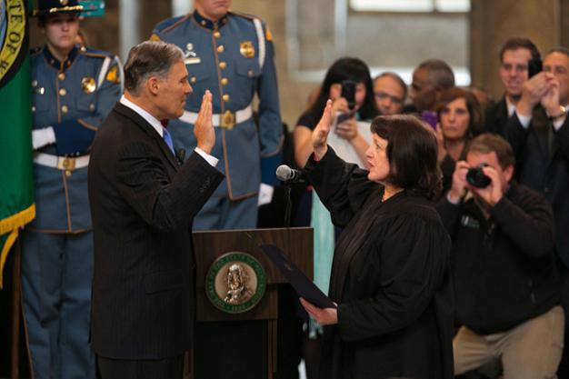 Washington State Supreme Court Chief Justice Barbara Madsen administers the oath of office to Governor Jay Inslee in the Olympia Capitol rotunda Wednesday