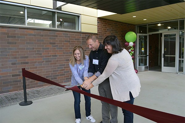 Islander Middle School co-principals Mary Jo Budzius and Aaron Miller and assistant principal Tara Stone cut the ribbon at the school’s dedication on Oct. 1.