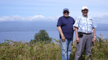 Paul Calderon stands with his host