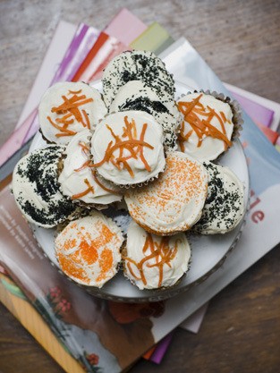 Carrot cake cupcakes with Halloween-themed decorations are a perfect October treat.