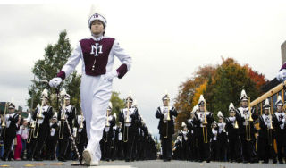 The Mercer Island High School marching band drum major Michelle Lee leads the way through the streets of downtown Mercer Island as part of the annual homecoming parade. For more pictures