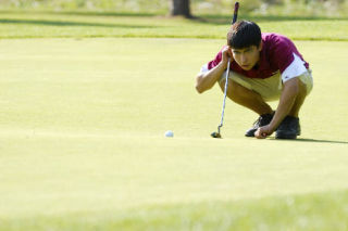 Islander Kyle Code surveys his putt line against Juanita at Twin Rivers Golf Course in Fall City last Tuesday