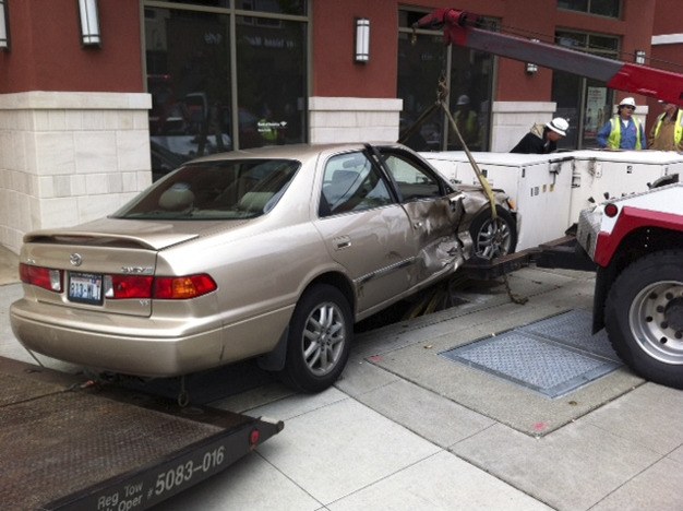 This car hit two electrical cabinets at the corner of S.E. 27th Street and 77th Avenue S.E. on June 25. A Puget Sound Energy crew ordered the power to be cut off at the north end substation to protect the public.