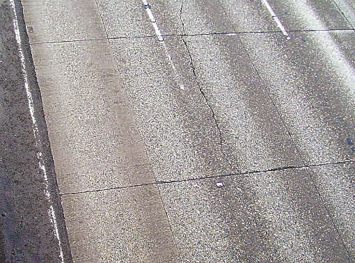 The pavement panel in the center of the photo provides a snapshot of the different kinds of pavement damage on northbound I-405 in Bellevue. Besides the large crack down the middle of the panel
