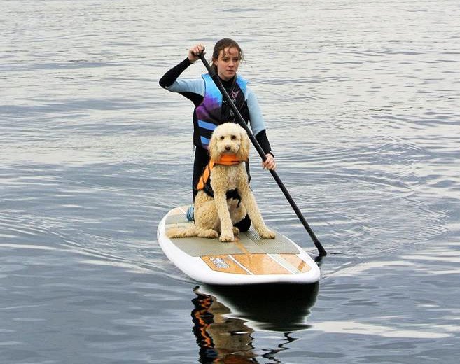 Sophie Lazarus takes her best friend Duffy for a paddle board ride on the lake.