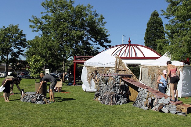 Seattle Shakespeare Company cast and crew members prepare the set for rehearsing 'The Tempest' in Mercerdale Park on Tuesday