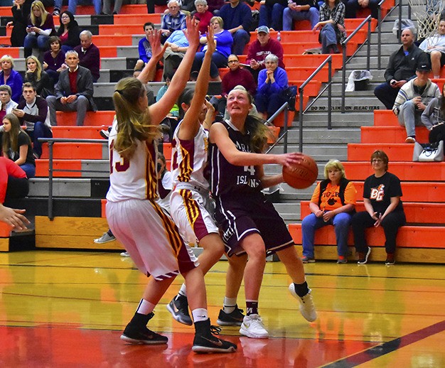 Mercer Island’s Jess Blakeslee fights for her shot against Prairie’s Macey Hsu (center) and Mallory Williams (13) during the Islanders’ regional matchup with the Falcons on Saturday at Battle Ground High School.