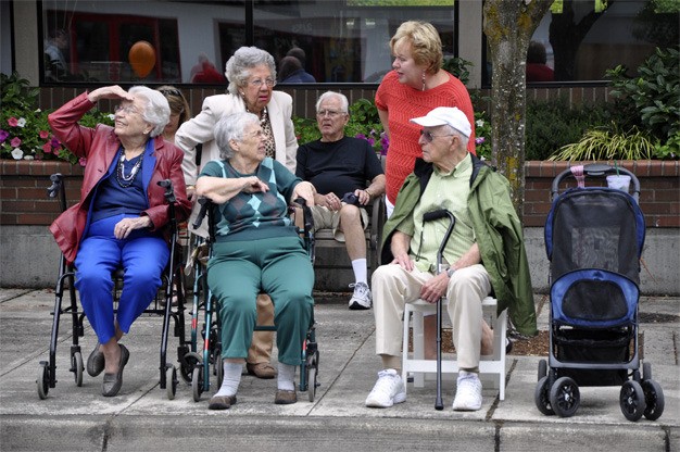 Mercer Island residents sit in front of Banner Bank on 78th Avenue S.E. on Saturday morning