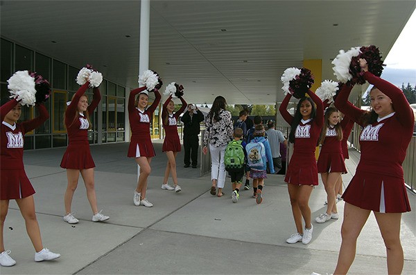 Mercer Island High School cheerleaders welcome new students to Northwood Elementary on Wednesday.