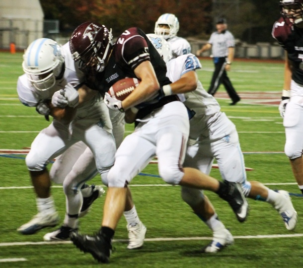 Mercer Island sophomore David Emanuels is tackled by Interlake's defense during the Islanders home win over the Saints on Friday