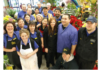 Employees of the North-end QFC — from the bakery to produce to Starbucks baristas — gather for a group shot with Manager Ted Saalfeld (back