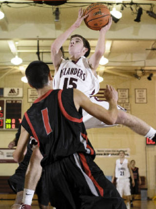 Islander guard Robbie Taylor drives to the basket against Ballard at Mercer Island High School