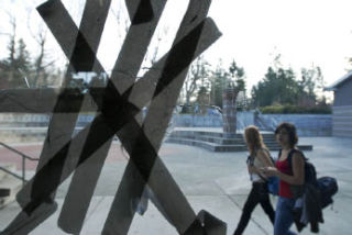 A broken window pane is reinforced with duct tape in the Commons at Mercer Island High School on Thursday