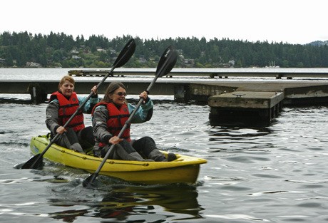 Kayakers Barb Gronseth (front) and Whende Keatts pulled on their wetsuits and set off in their kayak at Luther Burbank Park despite the downpour on Sunday. The two were instructors for a free kayak event set up by the city’s Parks and Recreation. But no one came.