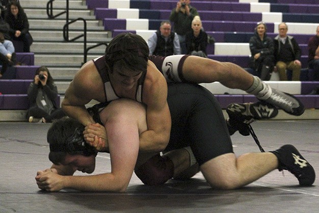 Mercer Island's Evan Condon wraps up Lake Washington's Martin Berger during the 285 match of the Islanders' dual meet with the Kangs Thursday