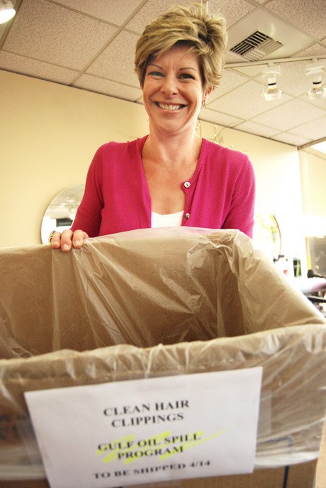 Au Courant owner Barbara Hovsepian holds up a box for collected hair on May 12. The hair will be donated to the Mexican Gulf oil spill through a national clean-up program.