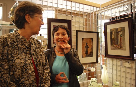 Artists Mary McKelvey and Sharon Driscoll laugh during the Third Thursday Art Walk on May 20. Both women had their artwork on display at the MIVAL gallery.