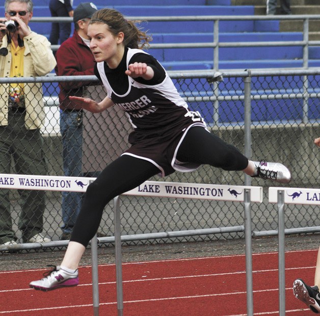Mercer Island senior Cora Miller clears a hurdle during the 100 meter race at the KingCo meet on Friday