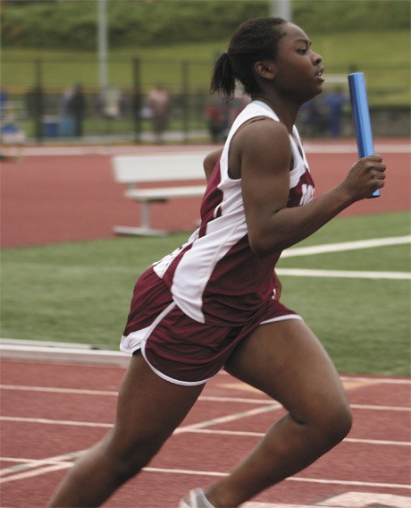 Queen Opoku runs the first leg of the girls 4x200 meter relay during Wednesday afternoon’s SeaKing District track and field meet. The top competitors in Wednesday’s prelim’s moved on to the finals on Friday for a chance to race in the state meet this week.