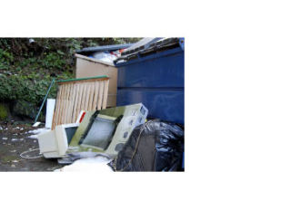 Computer equipment along with other trash sits discarded behind an Island dumpster last month.