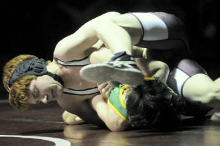 Islander Scott Mills twists his 185 pound opponent into a pretzel during his win