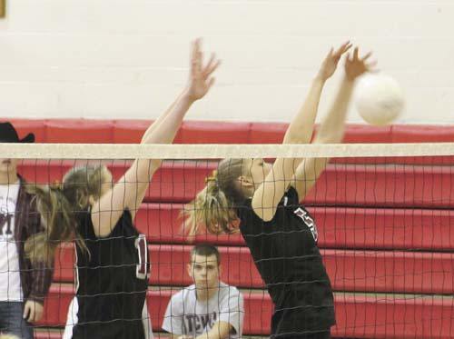 Sara Lindquist and Kris Brackmann jump to block a kill by Mount Si during the KingCo volleyball championship game last Saturday