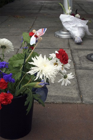 Flowers were placed at the base of the flagpole at the north end Mercer Island Fire Station in memory of Sept. 11