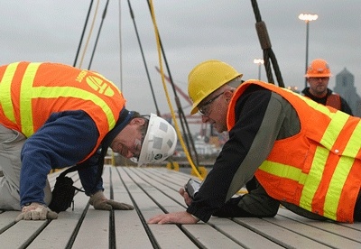 WSDOT bridge engineer specialist Ralph Dornsife (white hard hat) and project inspector Mike Hanson scrutinize the new I-90 floating bridge expansion joint two months ago at Terminal 30 in Seattle
