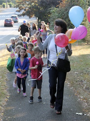 Pixie Hill Preschool students march along S.E. 40th Street from their old location to their new location