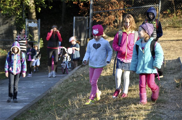 Children and parents participate in the annual Walk to School Day event at West Mercer Elementary on Wednesday morning